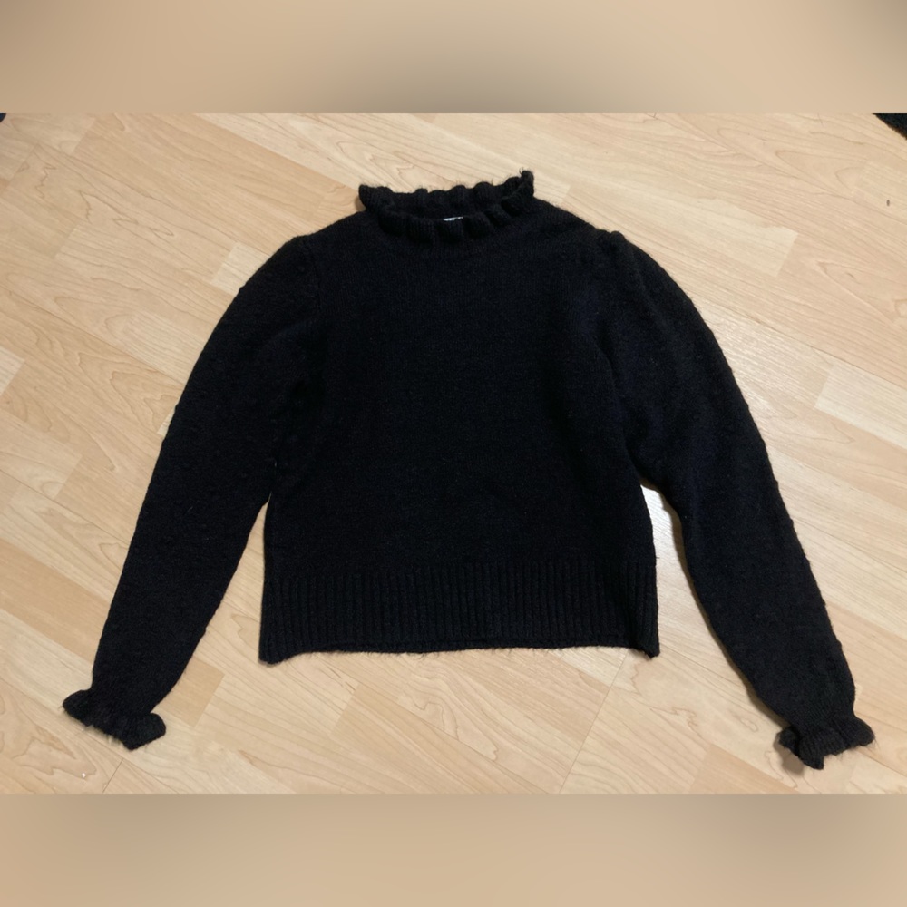 Black sweater with ruffled neck and sleeves